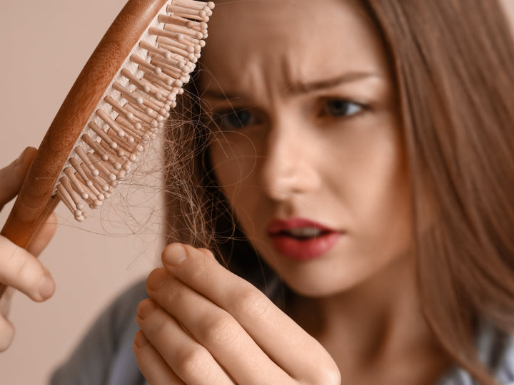 woman with shedding hair in hair brush