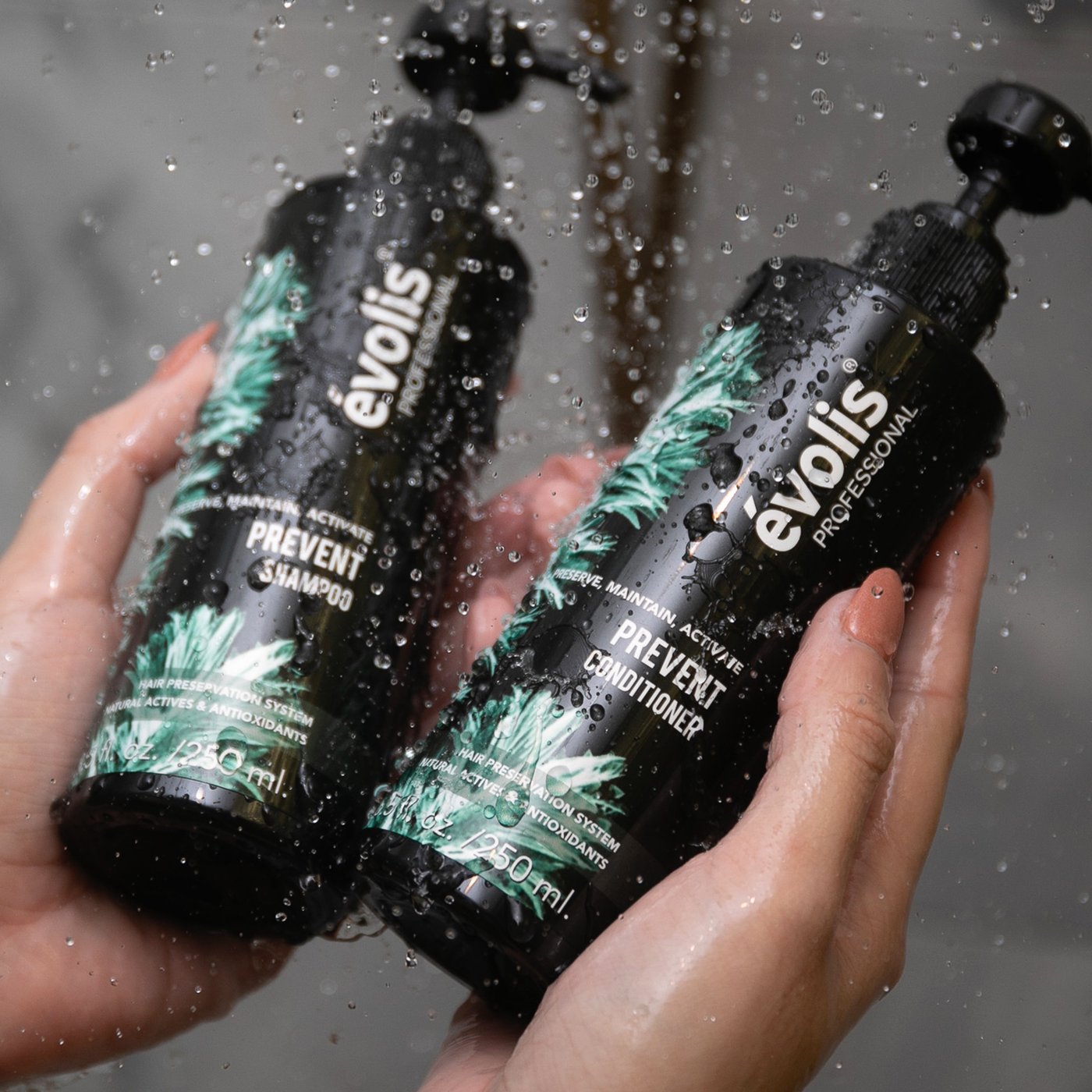 A woman holding the Evolis Prevent Shampoo & Conditioner bottles in the shower