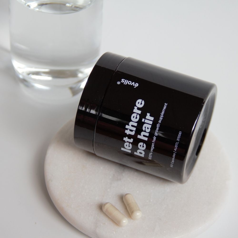 Evolis Let there be hair supplement bottle on its side