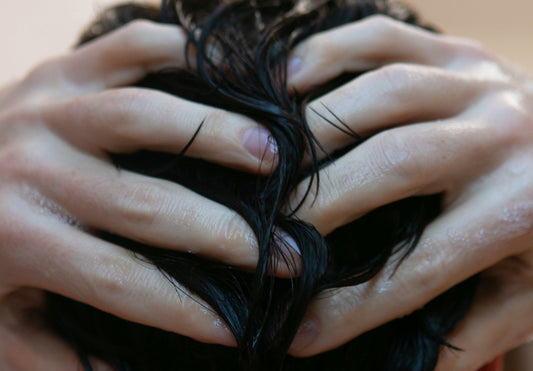 A man running his hands through his wet hair