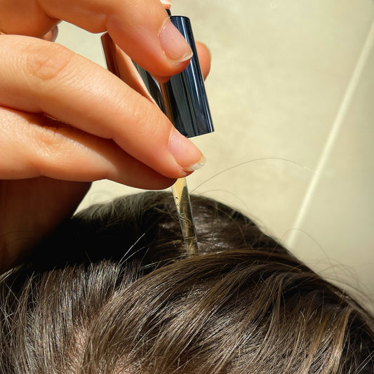 A woman applying the Evolis Activator Serum
