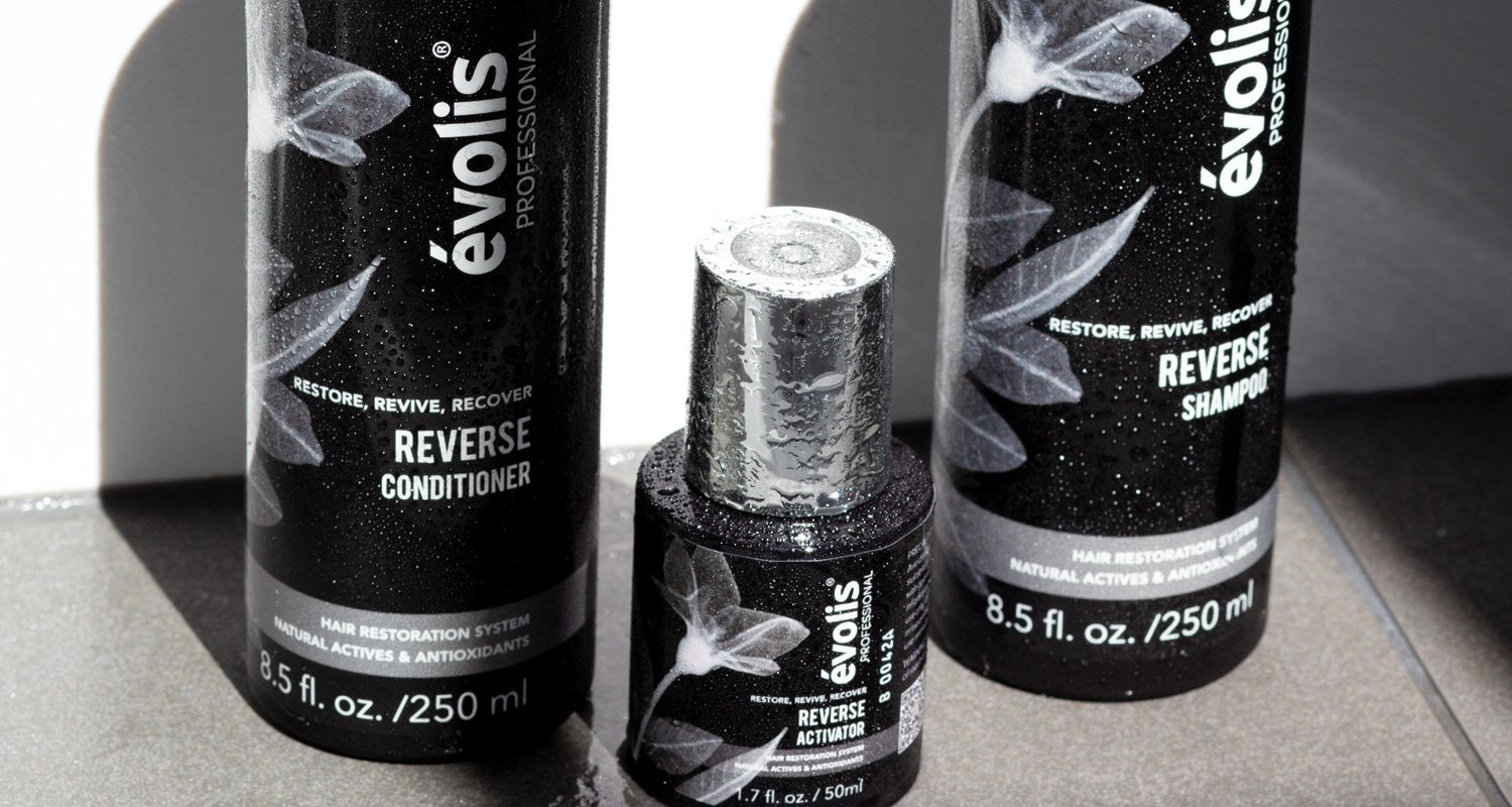 A close up shot of the Evolis Reverse 3 step system (Activator, Shampoo, & Conditioner)